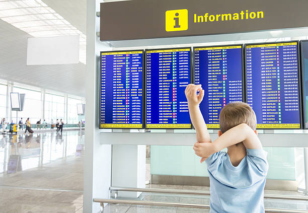 istock Rear view of bored kid looking panel flight times 505772171