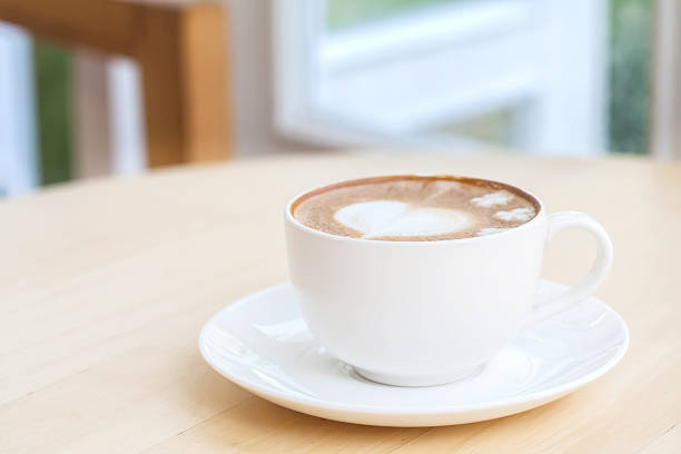 istock heart symbol on latte coffee cup on table 505772266