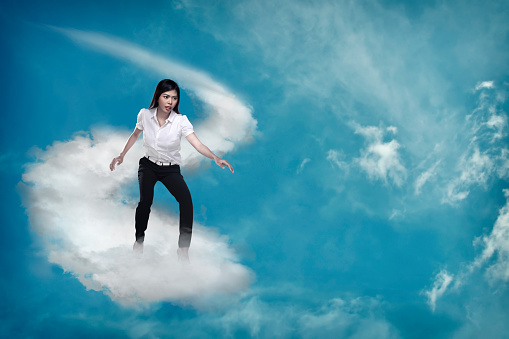 Asian business person flying with the cloud. Business challenge concept