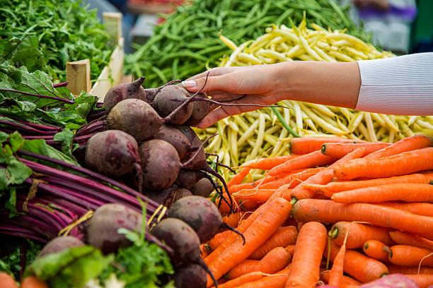 Woman buying vegetables on the market