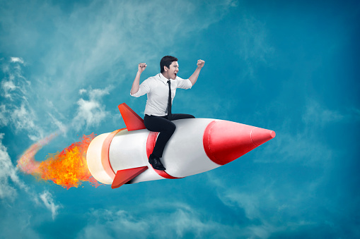 Image of asian business man flying ride rocket