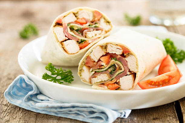 Chicken wraps Chicken wraps with pesto and bacon bacon wrapped stock pictures, royalty-free photos & images