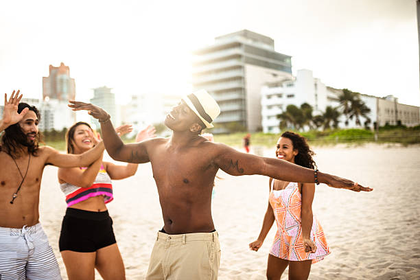 istock friends dancing on the beach for a party 505774700