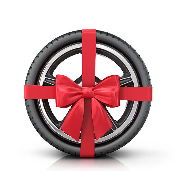 istock Car wheel wrap a red ribbon with a bow 505777202