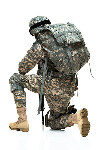 istock Rear view of army man kneeling 505792726