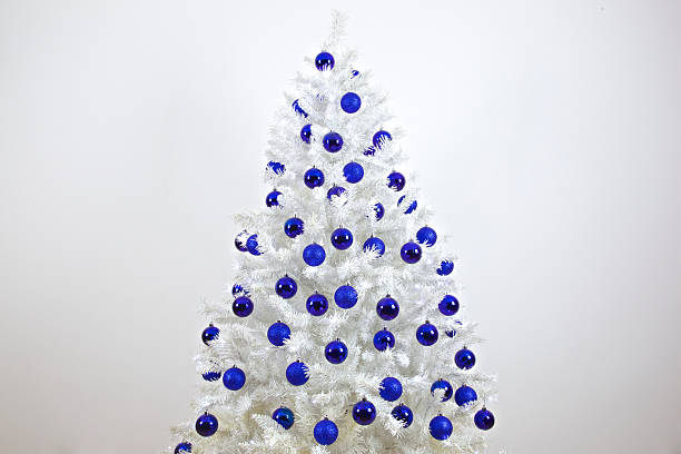 Background of silver, mirror, blue balls toys and lights on blue indoor Christmas tree for New Year