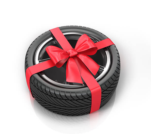 istock Car wheel wrap a red ribbon with a bow 505793392