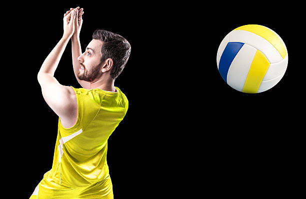 istock Volleyball player on yellow uniform on black background 505793934