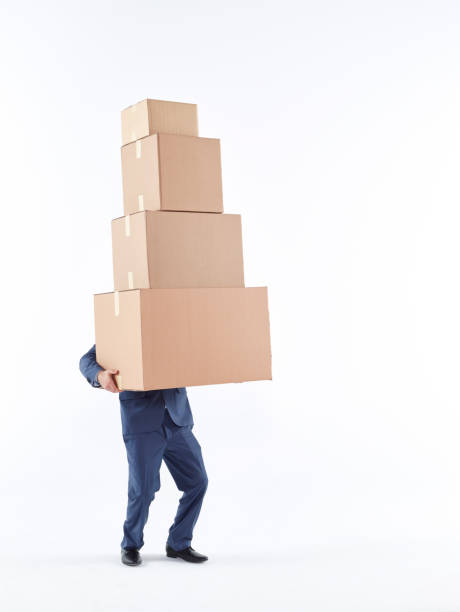 istock Man carrying heavy cardboard boxes 505794472