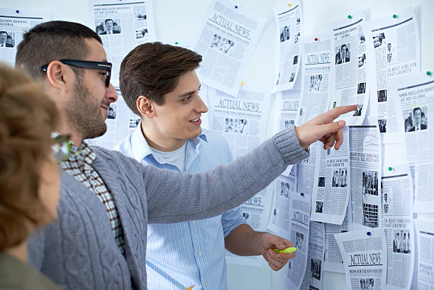 istock Discussing news from newspapers 505798362