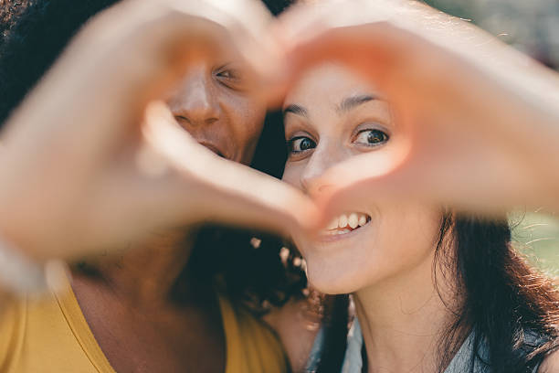 istock Girls making heart shaped symbol with hands 505798616