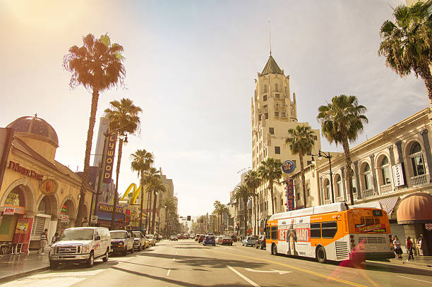 Walk of Fame on Hollywood Boulevard in Los Angeles California. Los Angeles, United States - March 21, 2015: front view of world famous Walk of Fame on Hollywood Boulevard before sunset in LA California. Warm nostalgic filter with late afternoon color tones and natural sunflares sunset strip stock pictures, royalty-free photos & images