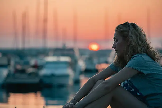 Photo of Depressed woman at the yacht port