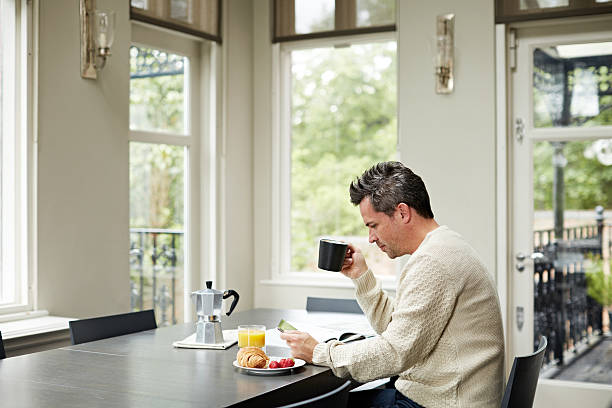 istock Catching up with the online news at breakfast 505801600