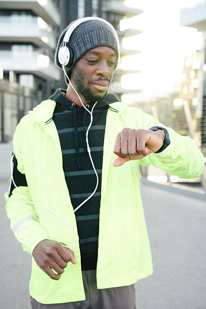 istock Cheerful Sport Man Looking At His Smart Watch 505802468
