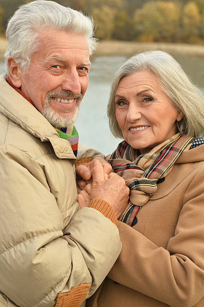 istock senior couple near river 505802622
