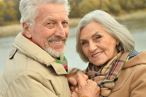 istock senior couple near river 505802836