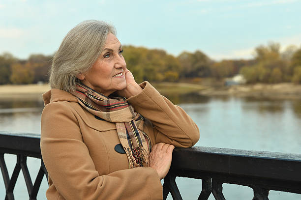 istock senior Woman near river 505803118