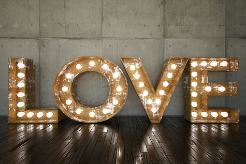 Lightbulb sign with LOVE against wall