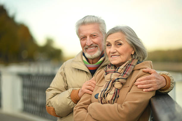 istock senior couple near river 505803690
