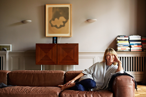 Portrait of a mature woman relaxing on her living room sofa