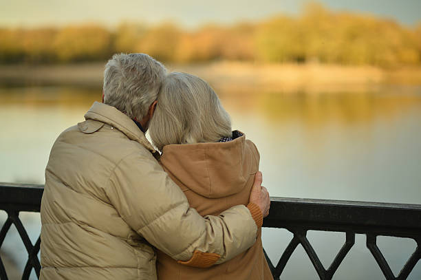 istock senior couple near river 505804438
