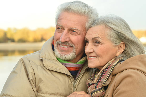istock senior couple near river 505804646