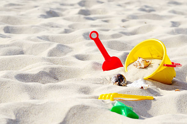 Summer beach toys in the sand concept for holiday and vacations