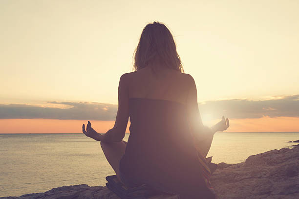 istock Woman practicing yoga on the beach. 505805504