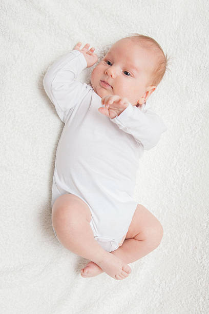 istock Newborn baby in white romper 505805718