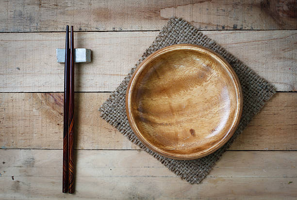 empty wood dish and chopsticks on wooden texture background