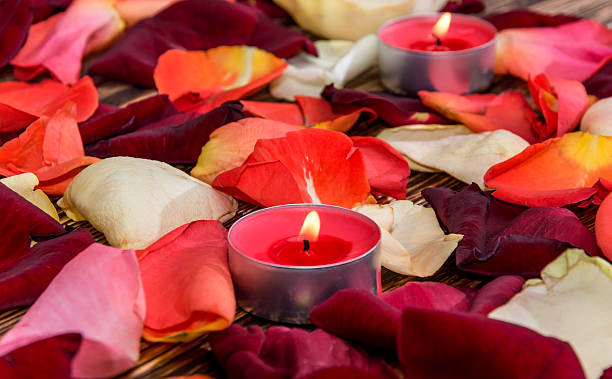 istock Candle with rose petals on wooden background 505817284