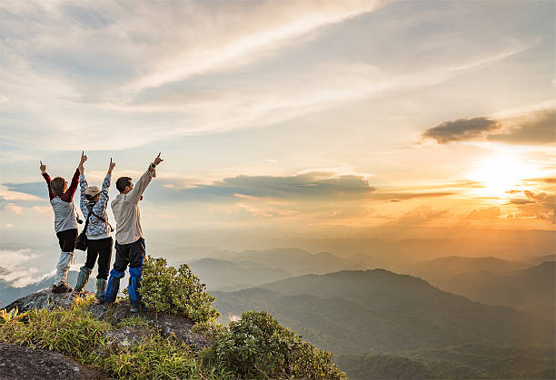 istock People on top mountain enjoying while the sun is setting 505817980