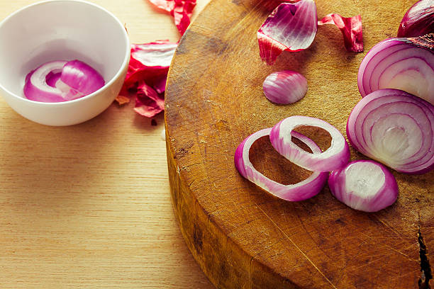 istock to slice purple onion on  wood board. 505818056