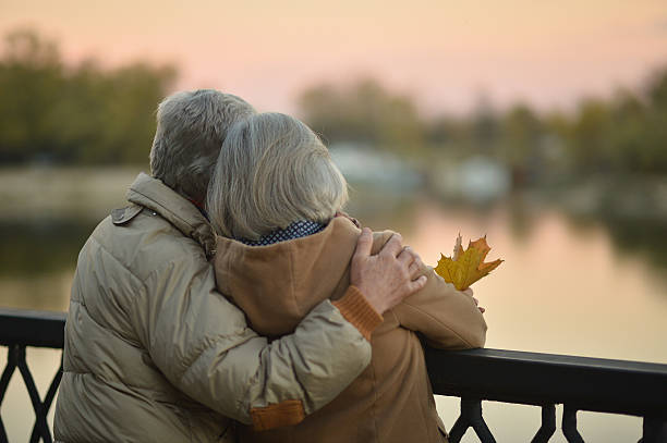 istock senior couple near river 505819318
