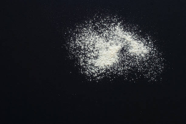 istock white flour on black background - free space for text 505820386