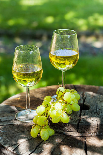 istock white wine with grapes on old wooden table 505822756