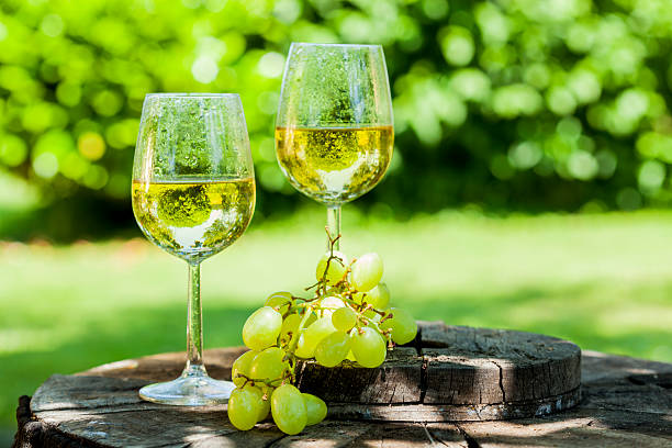 istock white wine with grapes on old wooden table 505822816