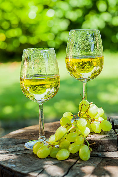 istock white wine with grapes on old wooden table 505822944