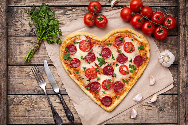 istock Heart shaped pizza for Valentines day with pepperoni, mozzarella, tomatoes 505825066