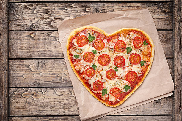 Heart shaped pizza margherita with tomatoes and mozzarella for Valentines stock photo