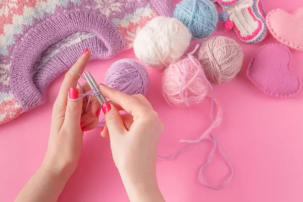 knitting leisure concept. Womans hands with yarn ball and strings