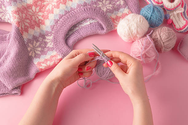 istock Womans hands with yarn ball and strings 505825902