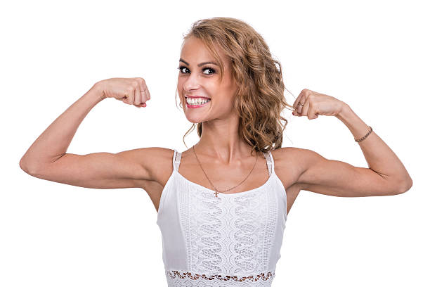 istock woman demonstrating biceps, isolated on white background 505827952