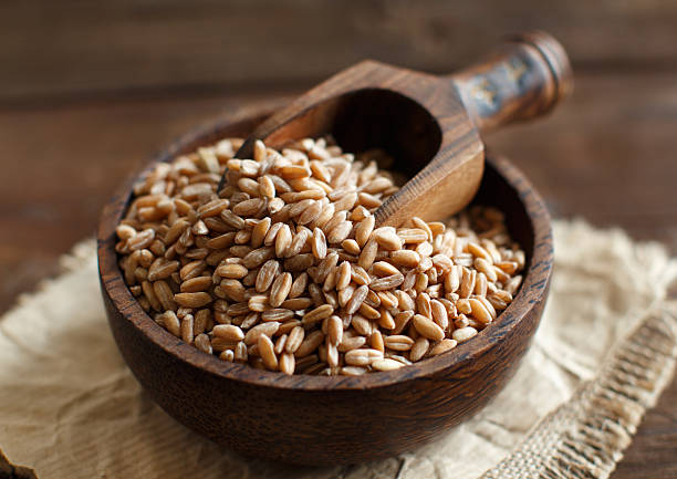 istock Uncooked Red rice in a bowl with a wooden spoon 505829888