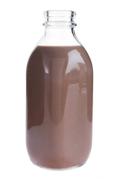 Photo of Glass bottle of chocolate milk on a white background