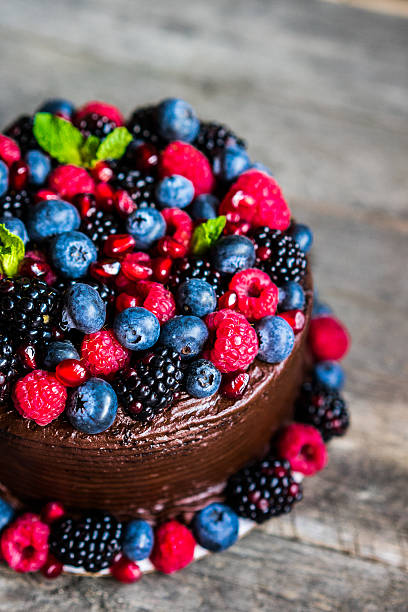 istock Chocolate cake with berries on wooden background 505830696