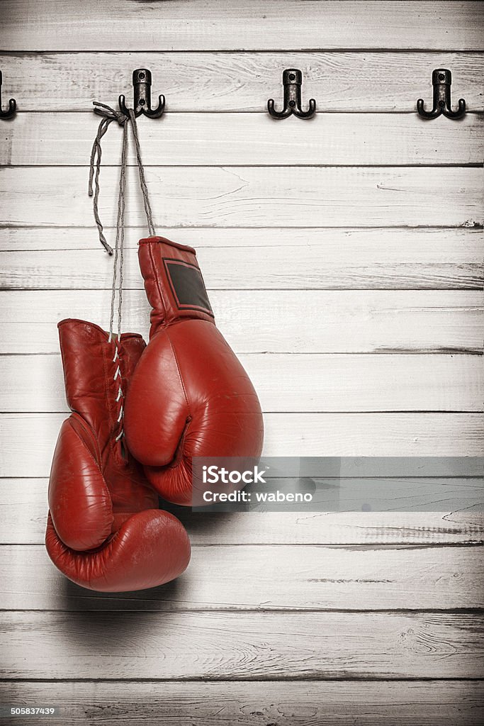 Boxing gloves hanging on wooden wall Boxing gloves hanging on wooden wall -including clipping path Boxing Glove Stock Photo