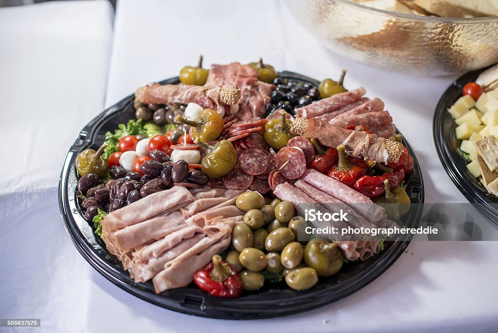 Italian Tray Platter containing many cold cuts, pepers, olives, and other vegetables. Antipasto Stock Photo