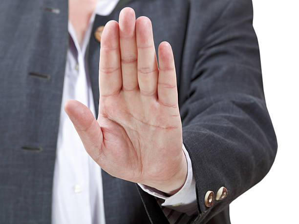 istock stop sign by open palm - businessman hand gesture 505839137